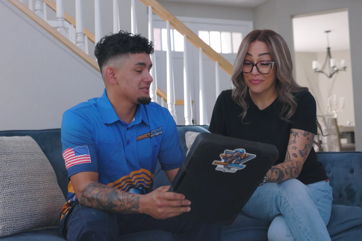 A Monkey Wrench technician going through findings with a homeowner in a Las Vegas living room